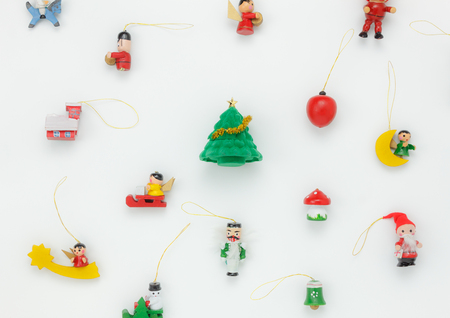Flat lay aerial image of decorations Merry Christmas and Happy new year concept.Fir tree with essential accessories on white background.Variety object arrangement decor for winter season and holidays.の写真素材