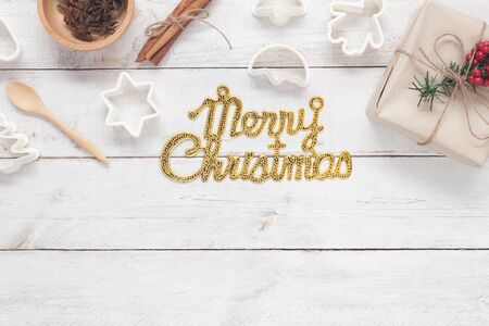 Table top view aerial image of Gold Merry Christmas text with cooking accessories.All idea for make...
