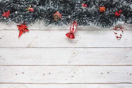 Above view aerial image of Christmas decoration & ornament background concept.Fir tree and essential items decor on the top of modern white wooden.Copy space for creative design beautiful wording.の写真素材