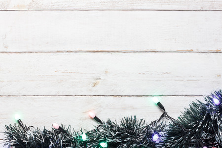 Table top view aerial image of lighting bulb and fir tree.Decorations & ornaments Merry Christmas & Happy new year background concept.Object on modern grunge white wooden at home office desk studio.の写真素材