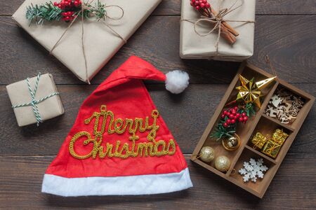 Table top view aerial image of ornaments & decorations Merry Christmas & Happy New year background concept.several different items and text on modern rustic brown wooden at home office desk studio.の写真素材