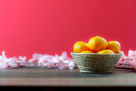 shot of accessories Chinese new year & decoration Lunar festival concept background.beautiful arrangement orange & items on modern rustic wood red wallpaper.Sign essential object for the decor season.