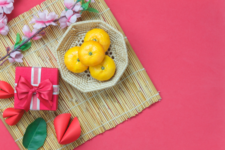 Above view of accessories Lunar New Year & Chinese New Year vacation background concept.Free space for mock up & Template.Essential objects on modern design red wooden at home office desk studio.の写真素材