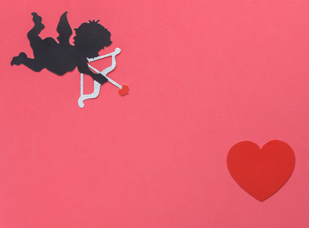 Table top view  aerial image of sign of valentines 's day background concept.DIY photo booth props the cupid shoot arrow to red heart on modern rustic pink wallpaper at home office desk studio.の写真素材