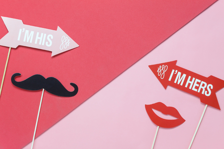 Table top view aerial image of valentine 's day background concept.DIY photo booth props paper crafts on modern pastel red & pink wallpaper at home studio.Idea for couple love in holiday season.の写真素材