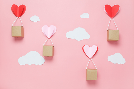 Table top view image of decoration valentine's day background concept.Text sign of season with paper cut balloon love on beautiful pink sky with cloud.Several objects on pink wallpaper.pastel tone.の写真素材