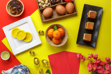 Table top view aerial image of accessories and Chinese new year and Lunar new year festival concept background.Mix variety object for the season.Difference items on modern red & yellow.pastel tone.の写真素材