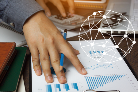 Double exposure world network system with finance & savings economy concept.Close up business man working on modern brown office desk about calculate cost form graph sheet document with calculator.の写真素材