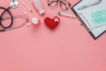 Flat lay aerial of accessories healthcare & medical background concept.Free space for mock up & template.Table top view objects on rustic pink paper.An idea for essential tools doctor in hospital.の写真素材