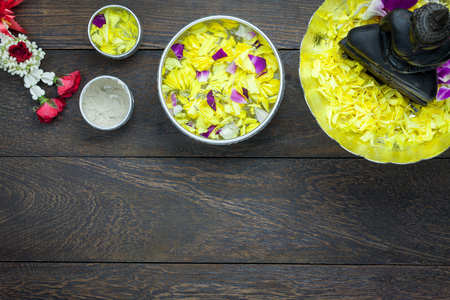 Table top view decoration & sign on Songkran festival or Thailand new year holiday background concept.Flat lay object for Worship the Buddha in season.Jasmine garland & blossom and item on brown wood.の写真素材