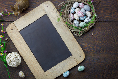 Shot of decoration Happy Easter holiday background concept.Arrangement bunny eggs on the modern rustic brown wooden table at home office desk with green nature backdrop.Negative space for creative.の写真素材
