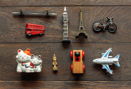 Flat lay aerial image of travel background concept.Table top view of souvenir symbol location or landmark of place for traveler all the world.Many difference objects on modern rustic brown wooden.の写真素材