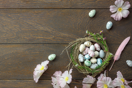 Table top view shot of decoration Happy Easter holiday background concept.Flat lay essential objects with bunny eggs on modern brown wooden at office desk.Negative space for creative design text.の写真素材
