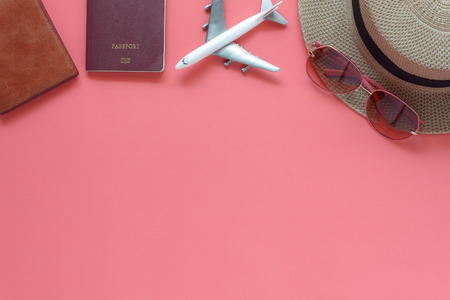 Table top view accessory of clothing women plan to travel in holiday background.Beauty & Fashion concept.Flat lay of hand bag with many essential items cosmetic and sun glasses on modern pink paper.の写真素材