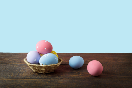 Shot of decoration Happy Easter holiday background concept.Arrangement bunny eggs on the modern rustic brown wooden table at home office desk with green nature backdrop.Negative space for creative.の写真素材