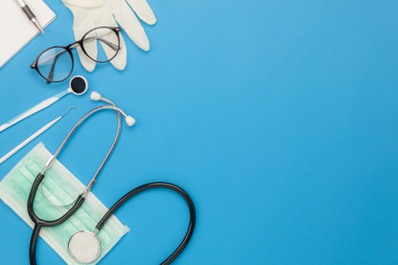 Table top view aerial image of accessories healthcare & medical background concept.Essential instruments or equipment tools on blue paper.Flat lay essential items for doctor using treat patient.の写真素材