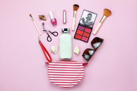 Table top view women fashion & beauty for travel summer holiday background concept.Flat lay accessories objects sun glasses & sun block body lotion on modern rustic pink paper wallpaper and copy spaceの写真素材