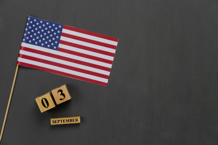 Table top view aerial image of decoration the sign of USA labor day on Sep 3,2018 background concept. Flat lay accessories US flag and date & month on modern rustic black wooden with copy space.の写真素材