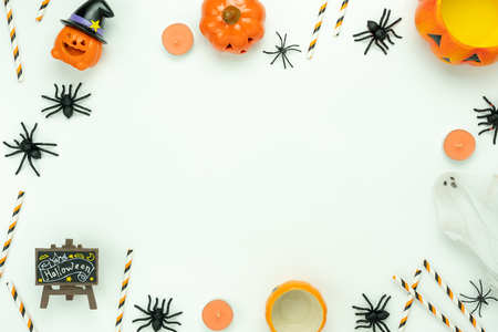 Table top view aerial image of decoration Happy Halloween day background concept.Flat lay accessories essential object to party the pumpkin & spider decor on white wooden.Space for creative design.の写真素材