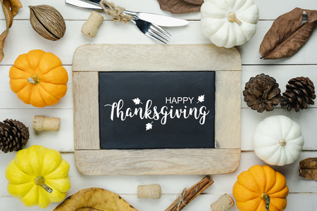 Table top view aerial image of decoration Happy Halloween or Thanksgiving day background concept.Flat lay accessory object to party the pumpkin & blackboard on white wooden.Text on season design.の写真素材