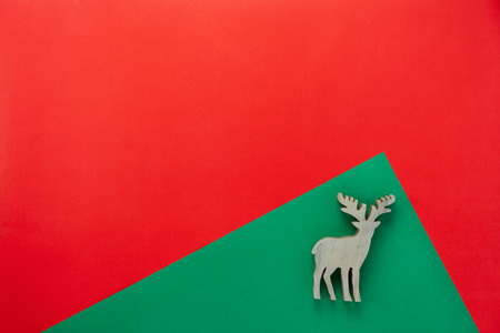 Table top view of Merry Christmas decorations & Happy new year ornaments concept.Flat lay essential difference objects reindeer toy wood on modern red & green paper background at home office desk.の写真素材