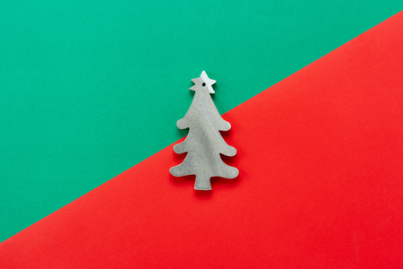 Table top view of Merry Christmas decorations & Happy new year ornaments concept.Flat lay essential object the wooden fir tree on modern rustic red & green paper background at home studio office desk.の写真素材