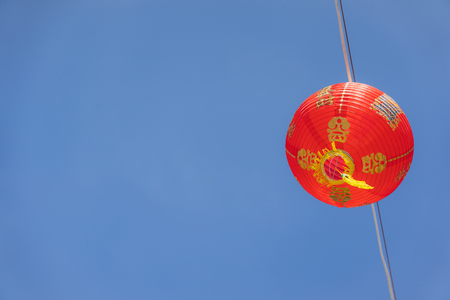 shot of arrangement decoration Chinese new year & lunar new year holiday background concept.China lantern hanging on beautiful blue sky on outdoor.Other language mean rich or wealthy and happy.の写真素材