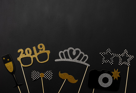 Table top view of Merry Christmas decorations & Happy new year 2019 ornaments concept.Flat lay essential difference objects to party season the photo booth prob on modern wooden black background.の写真素材