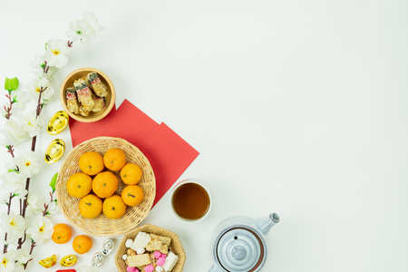 Top view aerial image shot of arrangement decoration Chinese new year & lunar new year holiday background concept.Flat lay fresh orange with food & drink on modern white wooden at home office desk.の写真素材