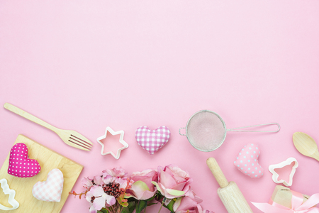 Table top view aerial image of decoration valentine's day background concept.Flat lay essential items love with cooking items with rose on modern pink paper.blank space for mock up creative design.の写真素材