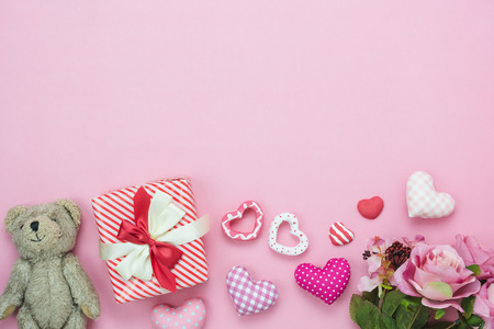 Table top view aerial image of decoration valentine's day background concept.Flat lay cute items.Variety pastel heart shape & gift box present with rose on modern rustic pink paper.copy space for textの写真素材