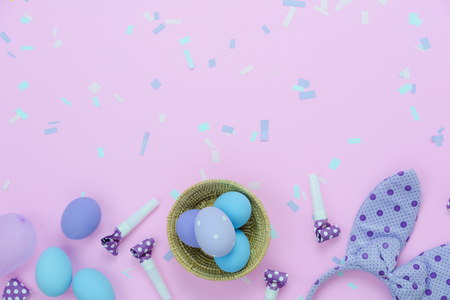 Table top view shot of decorations Happy Easter holiday background concept.Flat lay eggs with cute bunny ear & confetti for decor party festival on modern rustic pink paper.Copy space for design web.の写真素材