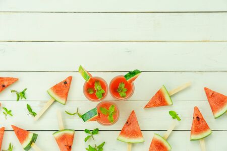 Table top view fruit tropical with drink with spring summer holiday & vacation background concept.Arrangement slices watermelon ice cream  pattern on modern white wooden.Copy space for design text.の写真素材