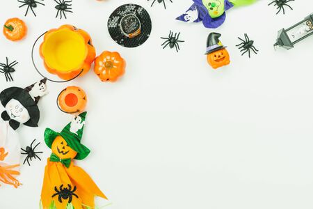 Table top view aerial image of decoration Happy Halloween day background concept.Flat lay accessories essential object to party the pumpkin & doll and hat on white wooden.Space for creative design.の写真素材