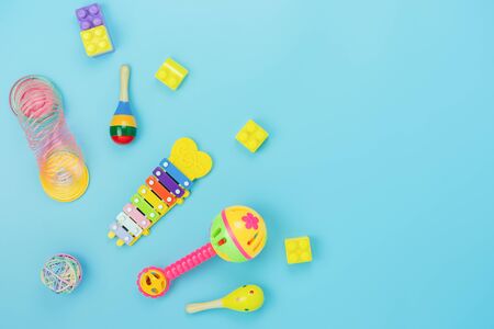 Table top view decoration kid toys for develop background concept.Flat lay accessories baby to play with items child on modern blue paper at office desk.Copy space for add text.pastel tone wallpaper.の写真素材