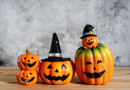 Accessories of decorations Happy Halloween day background concept.Variety of Jack O Lanterns pumpkins object to party season with spider on modern rustic brown & white stone backdrop.copy space.の写真素材