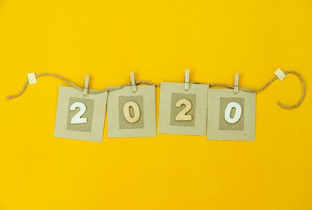 Table top view aerial image of Happy New Year 2020 & Christmas holiday logo text creativity inspiration concepts design.Text hanging on paper card concept.festive invitation card for welcome season.の写真素材