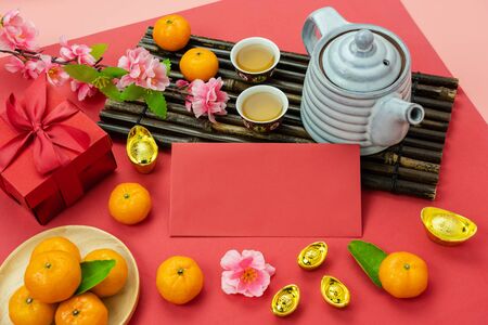 Red pocket money and pink flower with orange on modern red wallpaper.の写真素材