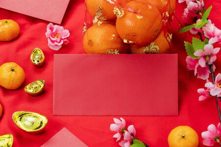 Red pocket money and pink flower with orange on modern red wallpaper.の写真素材