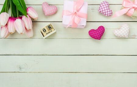 Table top view aerial image of decorations for international women's day  holiday concept background.Flat lay sign of season the word 8 march happy woman's day with heart shape on white wooden.の写真素材