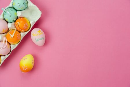 Top view shot of arrangement decoration Happy Easter holiday background concept.Flat lay colorful bunny eggs with accessory ornament on modern beautiful pink paper at office desk.Design pastel tone.の写真素材