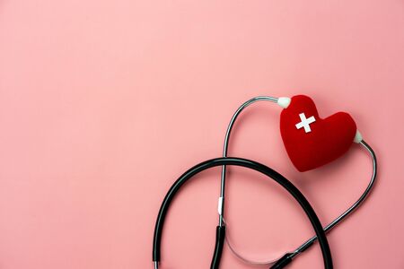 Table top view aerial image of accessories healthcare & medical with Valentines day background concept.Flat lay stethoscope with sign treatment heart shape sick on pink paper.National Organ Donor Day.の写真素材