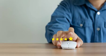 Young man hand feedback rating gold five star icon