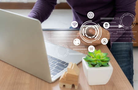 Business man wear purple shirt using mobile phone for digital online marketing on office desk. Business & finance technology concept.icon online e-commerce global market shopping,banking and payments.の写真素材