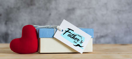 Objects on the table Happy Fathers day holiday background concept. Gift box with greeting card for love dad with accessories  sign of season the red heart Mustache. Blurred grey backdrop.の写真素材