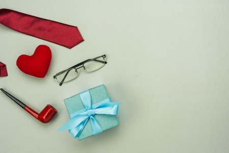 Table top view Happy Fathers day holiday background concept.Flat lay  gift box for dad with accessories objects sign of season on modern rustic grey paper at home office desk.space creative design.の写真素材