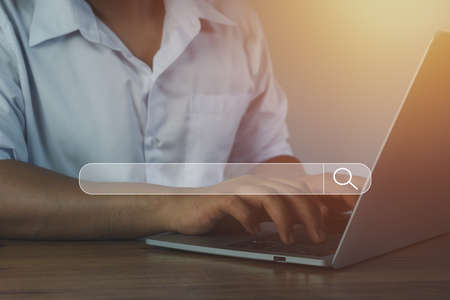 Hand businessman using laptop at home office workplace. Blank search bar webpage with browser of Internet data background. Searching on web search SEO engine network concept. Business technology .の写真素材