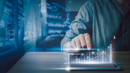 Close up Businessman using tablet for checking business growth up or stock market with data...