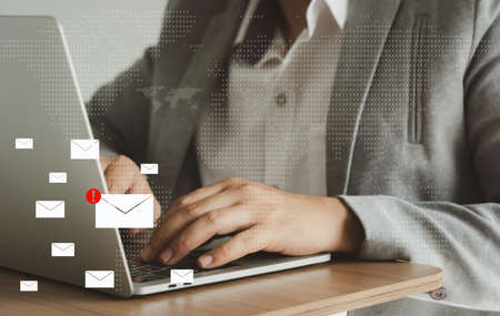 Business man using laptop about problem digital online marketing on office desk. Business - finance technology concept. icon online e-commerce. Spam email web from internet and hacker solution.の写真素材