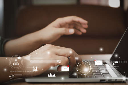 Business man using laptop for digital online marketing on office desk. Business - finance technology concept.icon online e-commerce global market shopping,banking and payments.planning and strategy.の写真素材